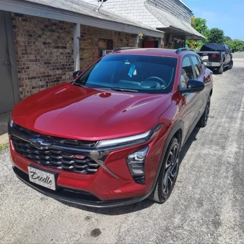Front view of a red Chevrolet SUV photographed after detailing.