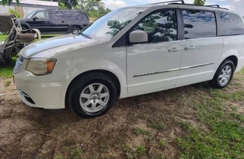Front three-quarter view of the white minivan after detailing.